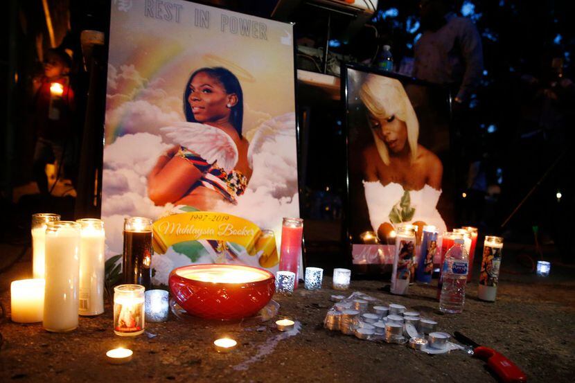 Candles surrounded photos of Muhlaysia Booker during a candlelight vigil in Dallas on May...