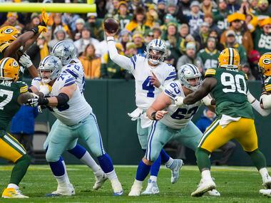 Dallas Cowboys quarterback Dak Prescott (4) throws a pass under pressure during the first...