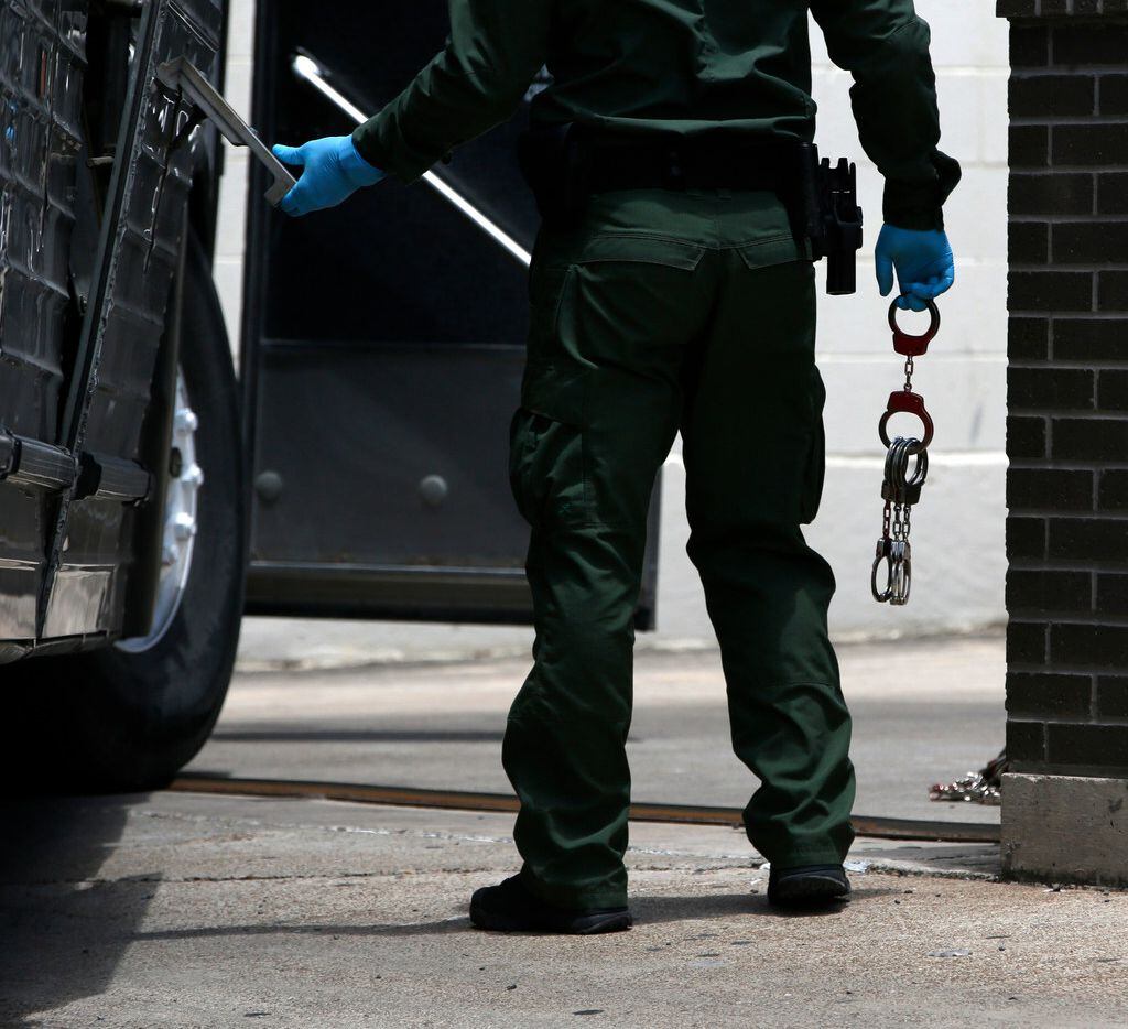 A U.S. Border patrol officer loaded up handcuffs (shown), along with chains and shackles (not shown) at the federal courthouse in McAllen, Texas on June 11, 2018. 