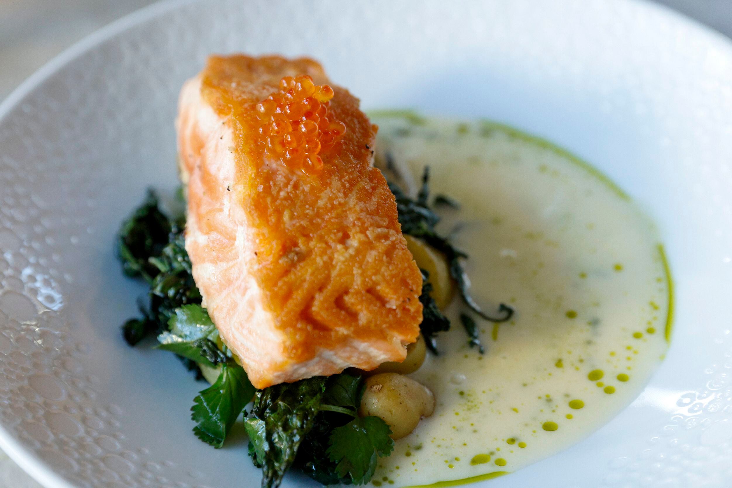 Roasted salmon with beurre blanc and kombu oil poured table side at Mirador restaurant in...