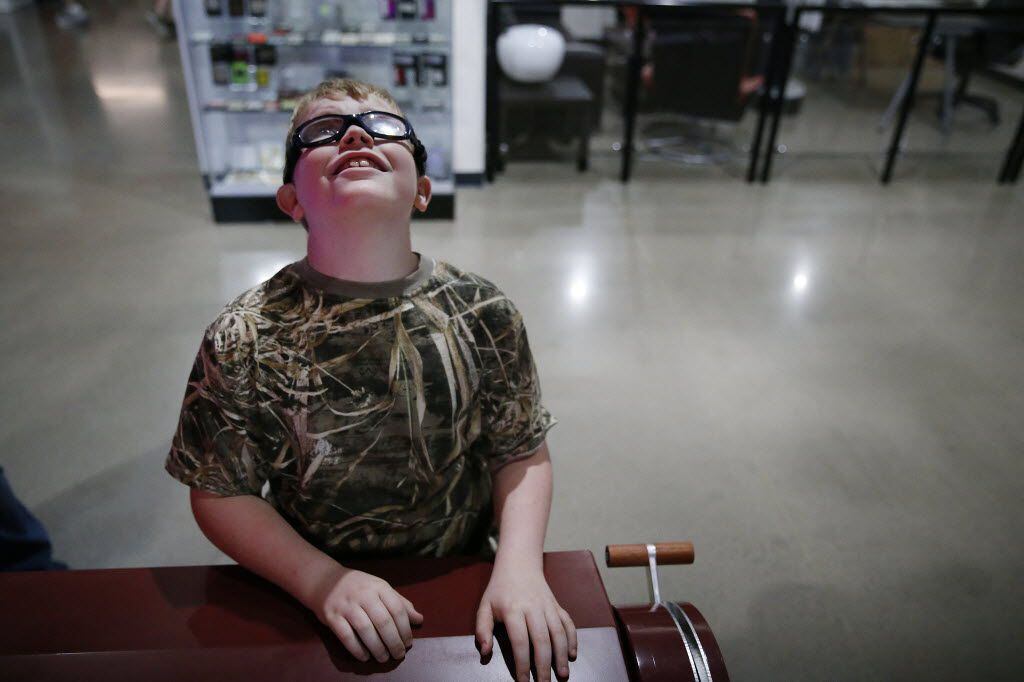 Jerry Smith, 10, plays a interactive game with his sister, Alyssa Smith, 7, both of...