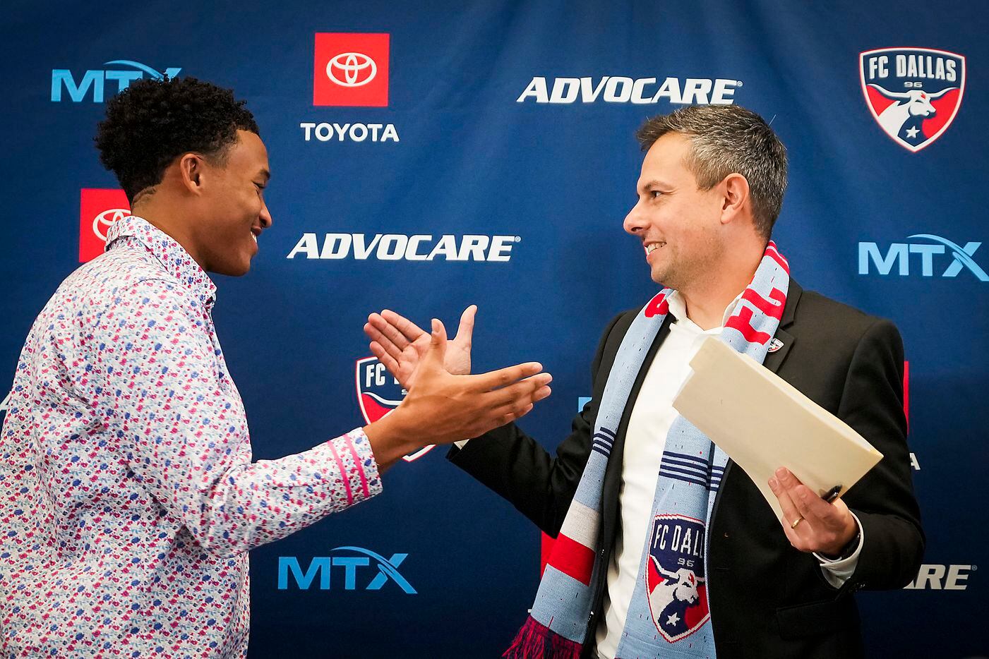 New FC Dallas head coach Nico Estévez (right) is congratulated by defender Collin Smith after his introductory press conference at the National Soccer Hall of Fame on Friday, Dec. 3, 2021, in Frisco, Texas.
