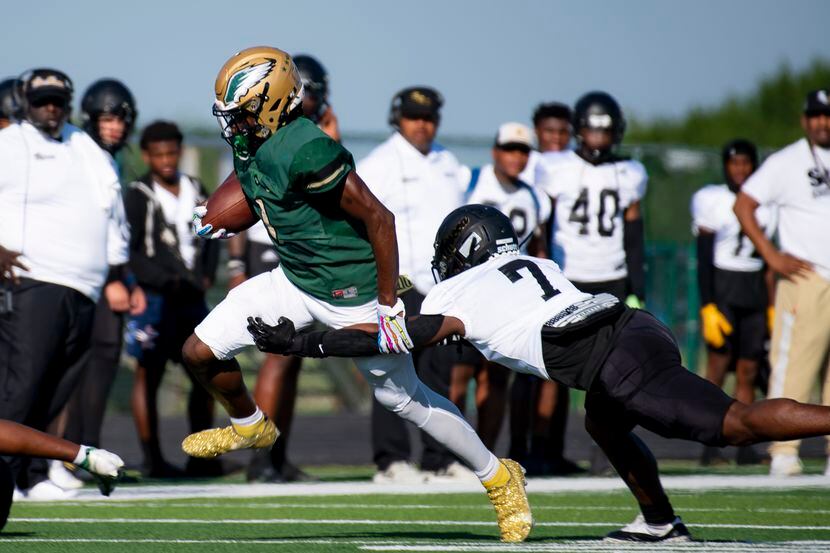 DeSoto senior Johnny Cook II (1) attempts to dodge a tackle by South Oak Cliff senior Adul...