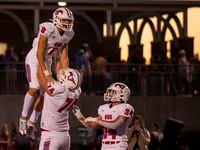 Grapevine senior Evan Baum (9) is hoisted in the air by senior Max Livingston (74) after...