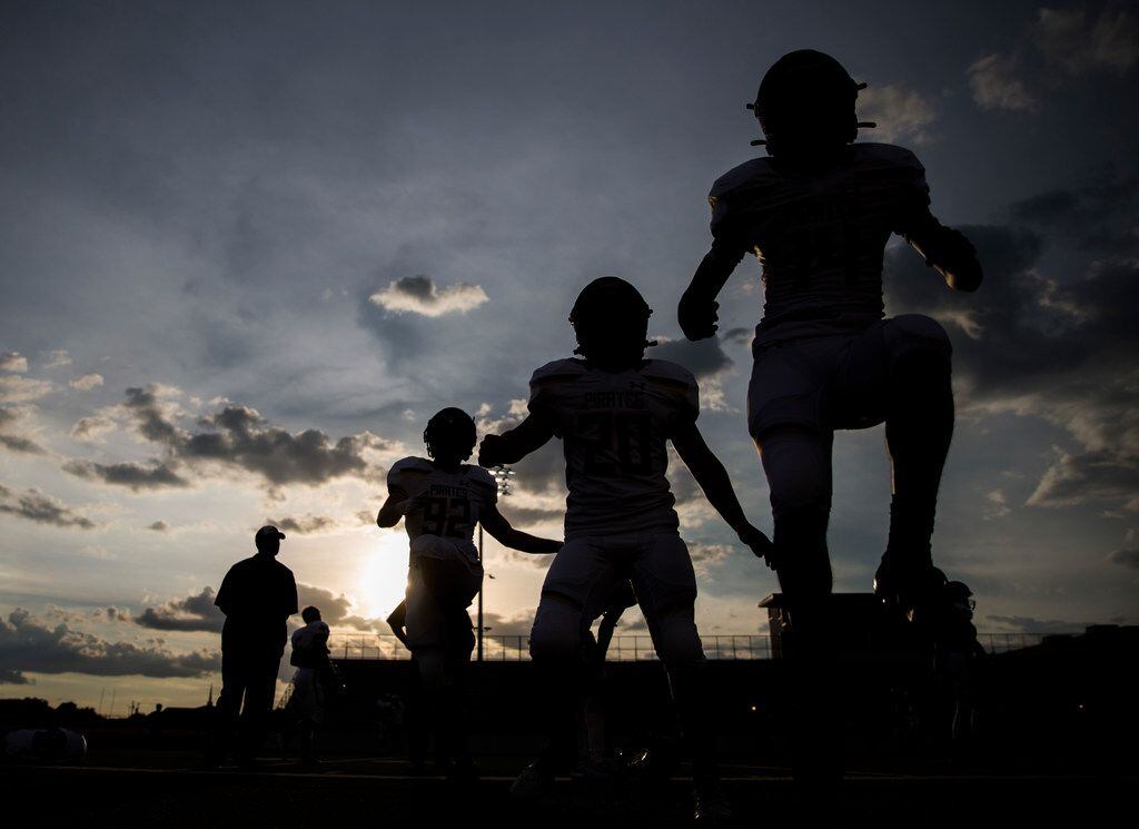 Crandall football players warm up before a 4A high school football game between Carter and...