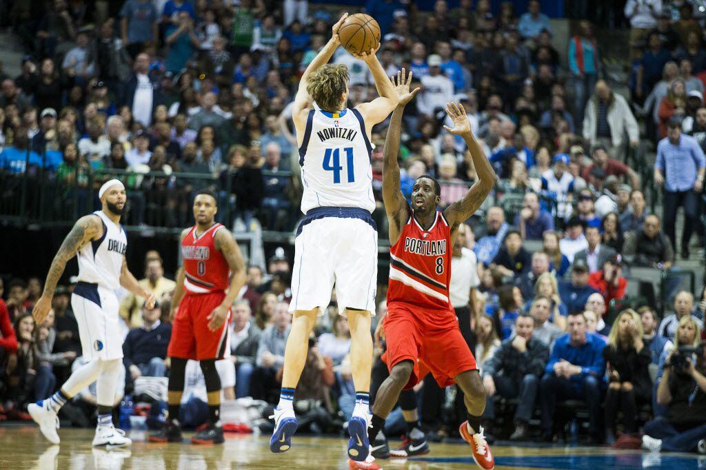 Dallas Mavericks forward Dirk Nowitzki (41) shoots a 3-pointer over Portland Trail Blazers...