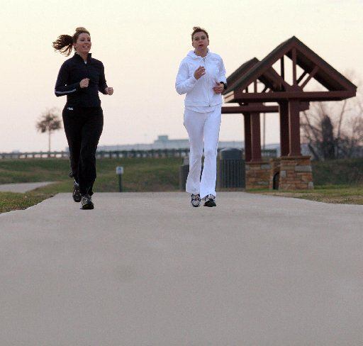 Runners jog along Irving's Campion Trail, which will soon connect to the city's downtown.