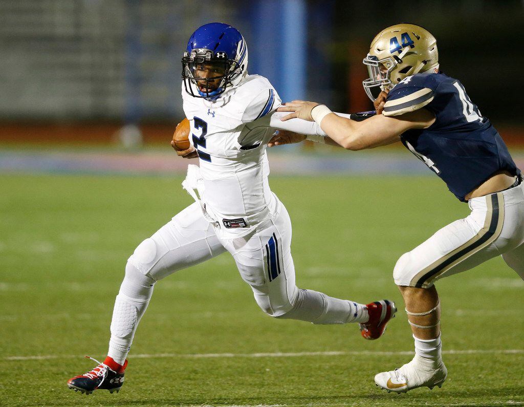 Trinity Christian's Shedeur Sanders (2) stiff arms Austin Regents Joseph Benson (44) during the second half of play at the TAPPS Division II State Championship game at Waco Midway's Panther Stadium in Hewitt, Texas on Friday, December 6, 2019. Trinity Christian defeated Austin Regents 48-19. (Vernon Bryant/The Dallas Morning News)