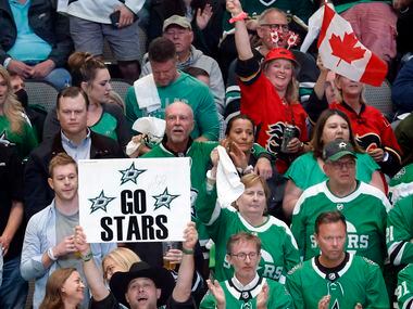 A pair Calgary Flames fans wave their Canadian flags amongst a sea of Dallas Stars fans...