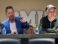 Pac-12 commissioner George Kliavkoff (right) talks with SMU athletic director Rick Hart as...