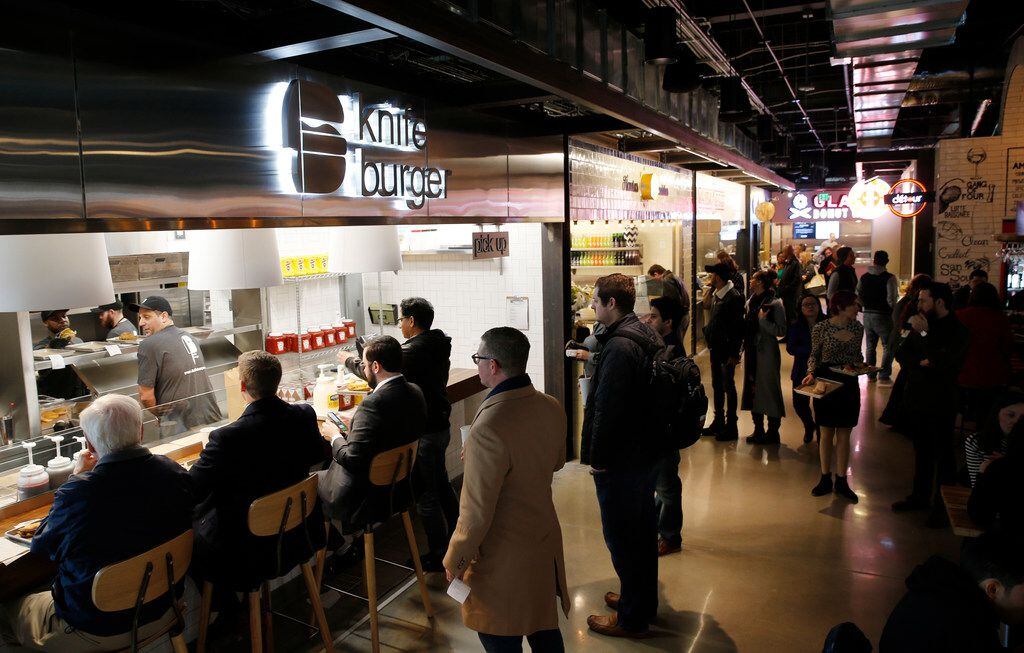 People wait in line at knife burger as others make their way around Legacy Hall during the...