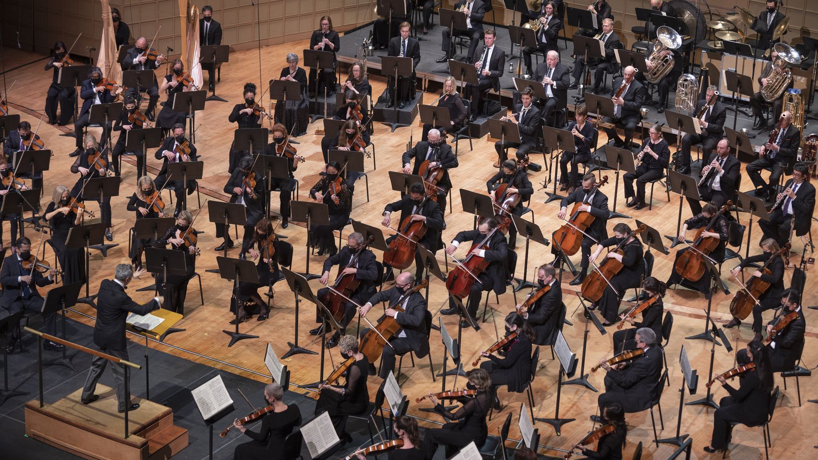 Dallas Symphony Orchestra music director Fabio Luisi (bottom left) conducts members of the...