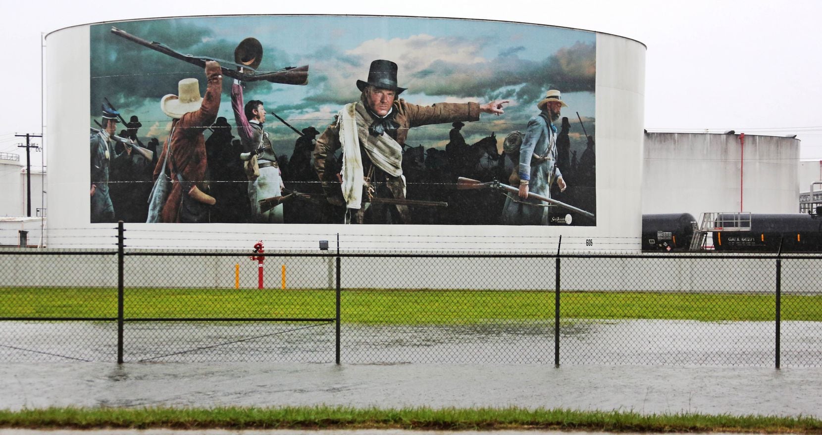 A painted oil tank bearing a painting of the Battle of San Jacinto is seen as the roadside...