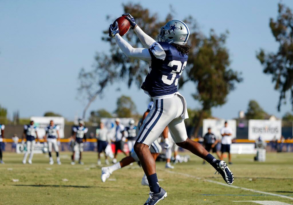 Dallas Cowboys cornerback Brandon Carr (39) comes down with a tipped pass for an...
