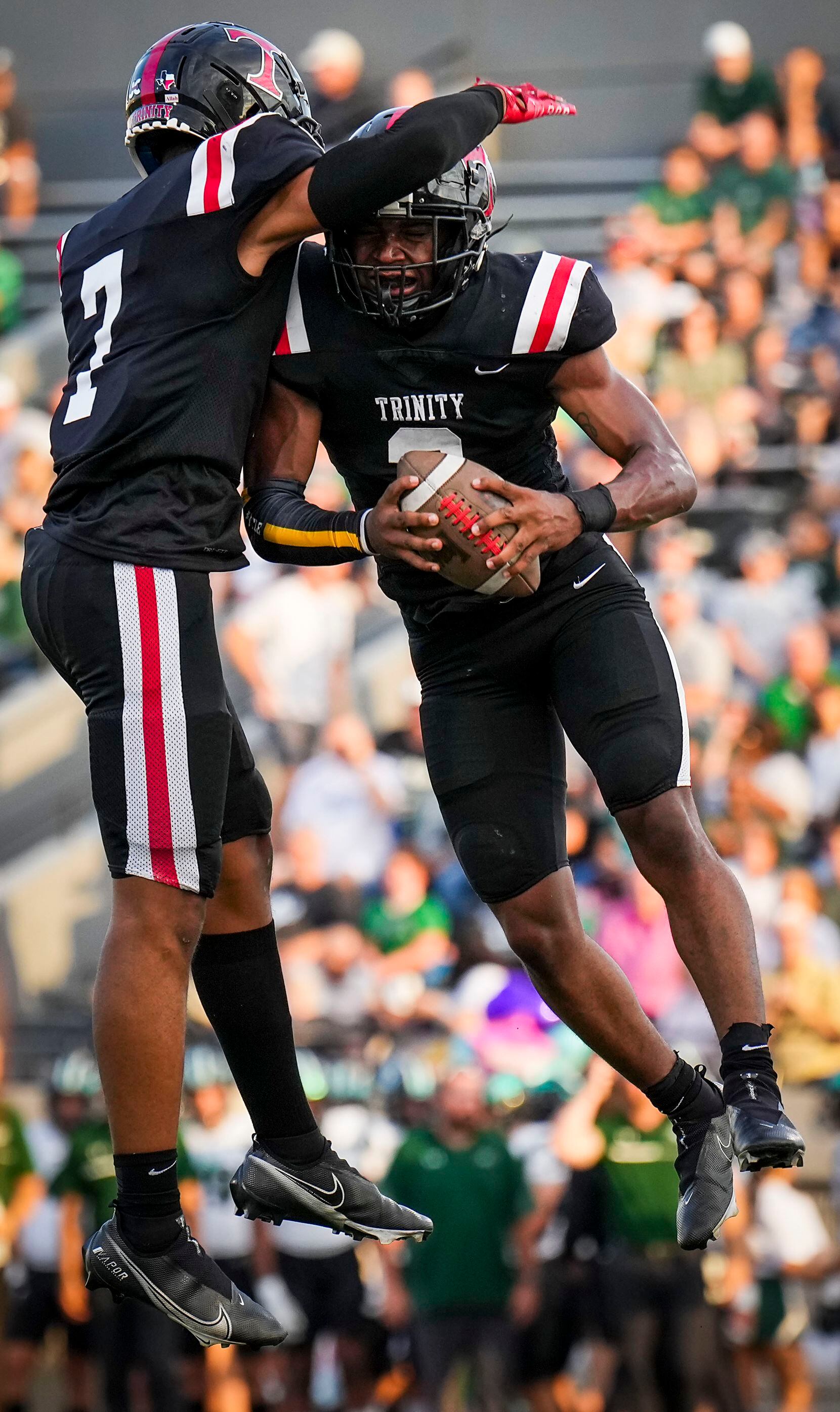 Euless Trinity running back  Gary Maddox (3) celebrates a touchdown with wide receiver Nasir...