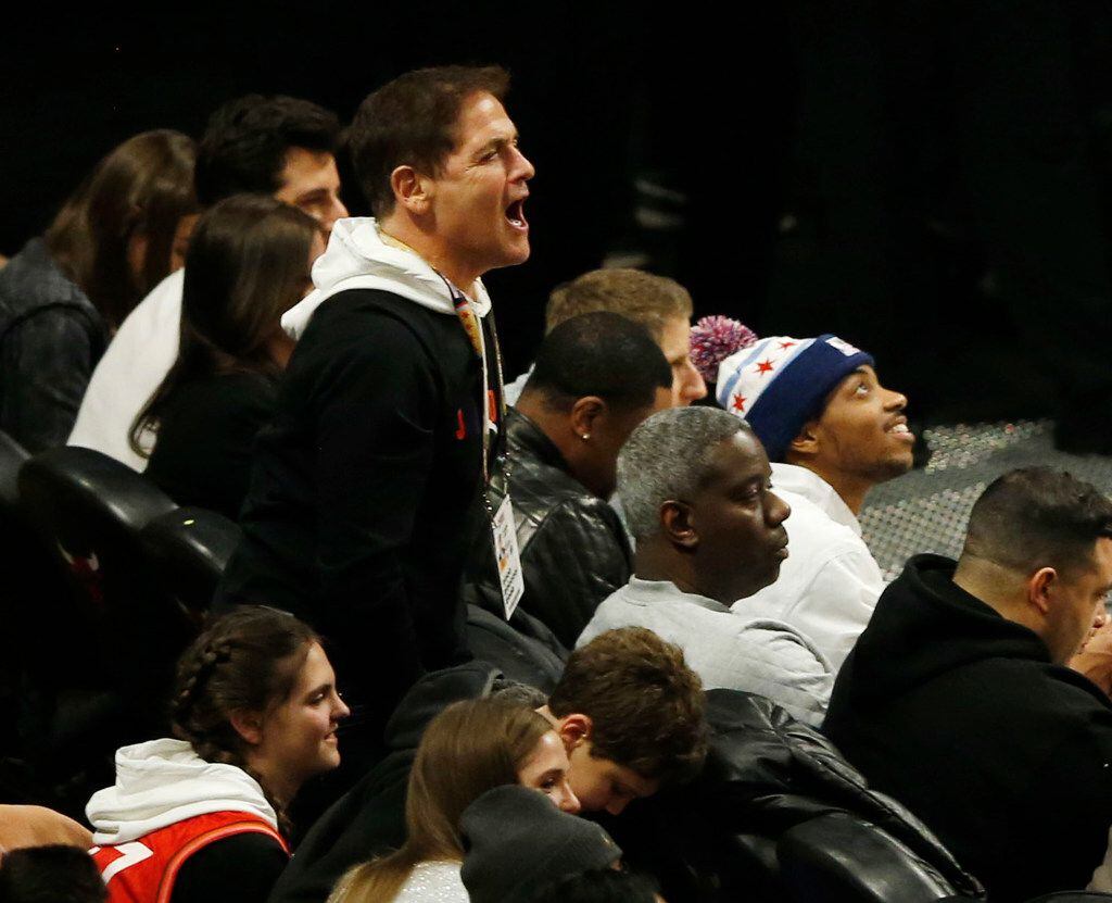 Dallas Mavericks owner Mark Cuban celebrates after Luka Doncic makes a three pointer in a...
