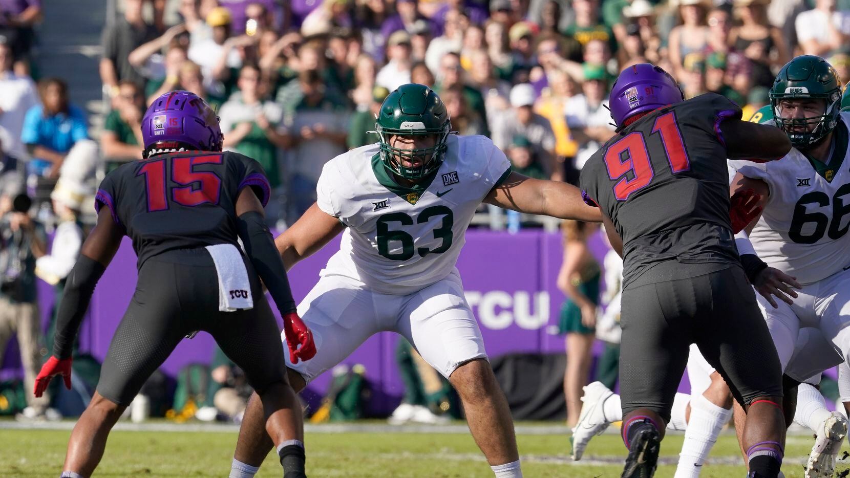 Baylor offensive lineman Grant Miller (63) defends against the rush by TCU safety Josh...
