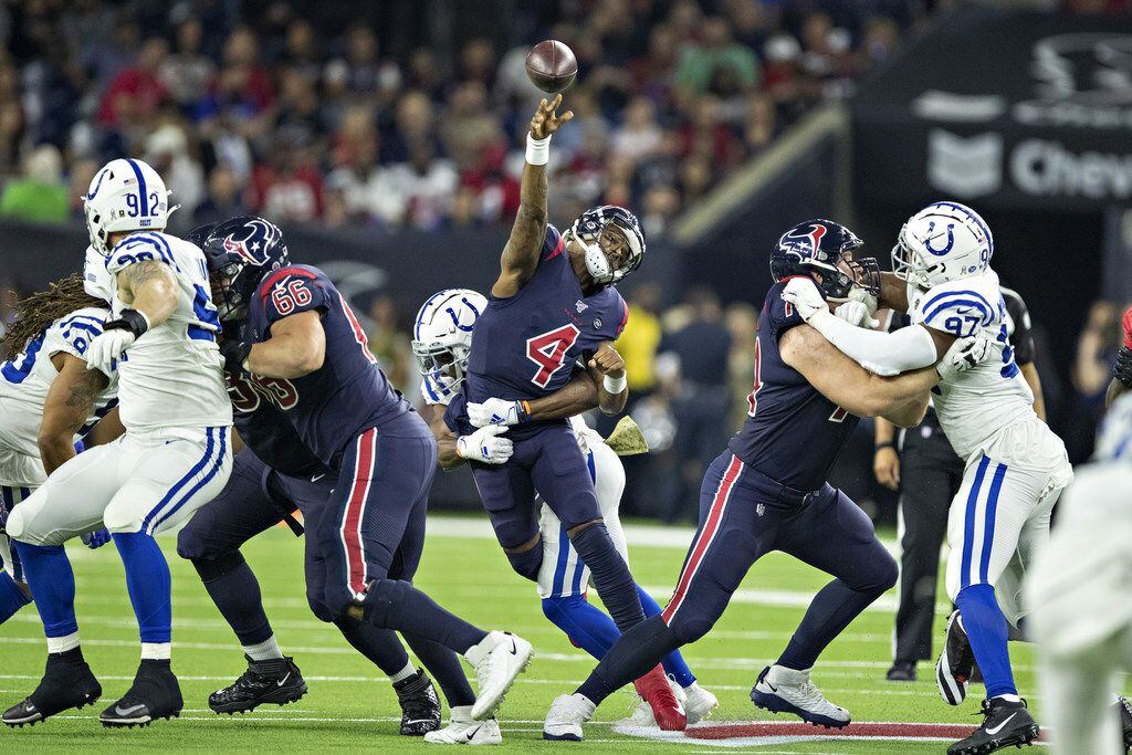 HOUSTON, TX - NOVEMBER 21:  Deshaun Watson #4 of the Houston Texans is hit while throwing a...