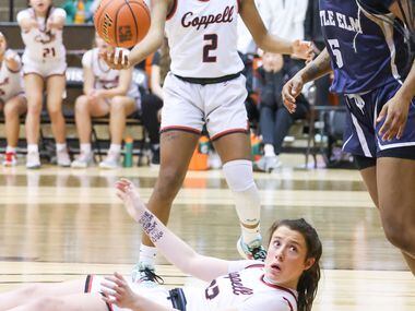 Coppell junior guard Ella Spiller (23) looks up from the ground where she landed while...