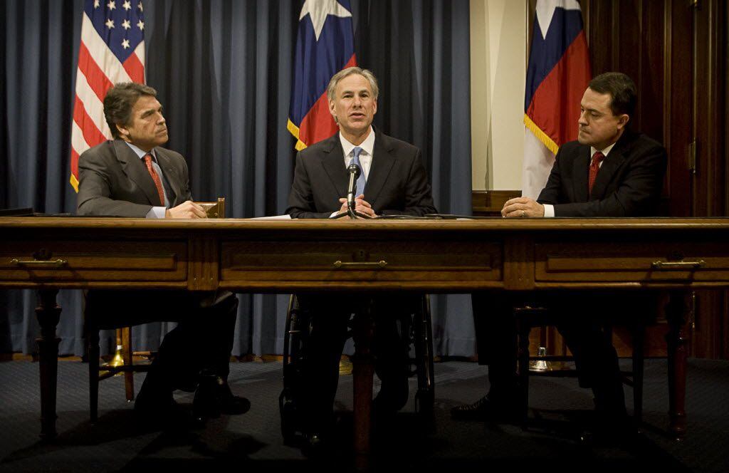 Texas Gov. Rick Perry, Attorney General Greg Abbott and Agriculture Commissioner Todd...