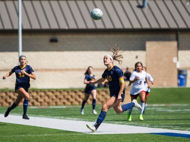 Highland Park forward Presley Echols (10) chases the ball after she headbutted it during the...