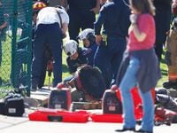 Arlington firefighters work to free girl from a storm drain at Swift Elementary School on...