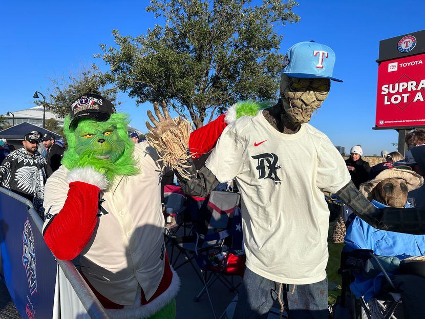 Jeremy Eckert, dressed as the Grinch, poses with Halloween decorations-turned-Rangers fans...