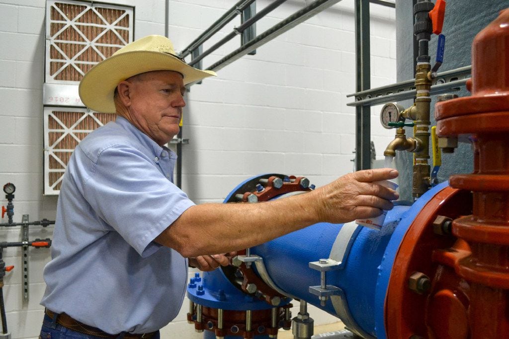 Public Works director Doug Hutcheson fills a cup with water at the water treatment plant in...