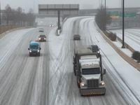 Traffic flows along an icy U.S. Highway 75 in Dallas during a winter storm on Tuesday, Jan....