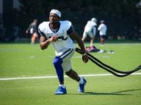 Dallas Cowboys wide receiver Michael Gallup (13) works with a resistance band during the...