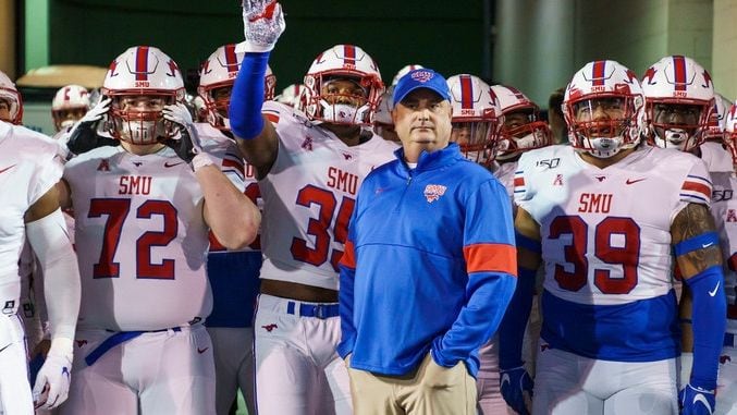 SMU head coach Sonny Dykes stands with his team before Mustangs take the field for an NCAA...