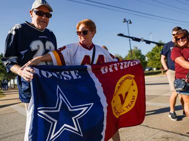 Tim and Stephanie Newman from Laurel Springs, NC Hold a house divided flag before the...