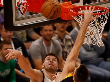 Dallas Mavericks guard Luka Doncic (77) blocks a shot attempt from Utah Jazz forward Juancho...