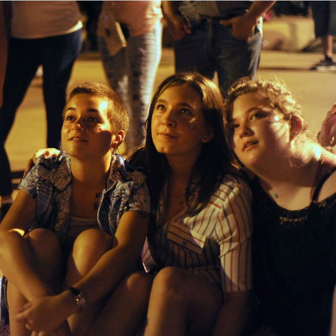 Friends watch the fireworks on the Margaret Hint Hill Bridge at Red, White, and Boom on the...