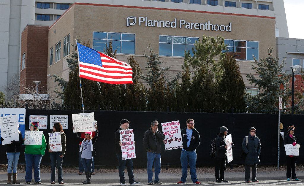 FILE - In this Feb. 11, 2017 file photo, pro-choice counter-protesters hold signs supporting...