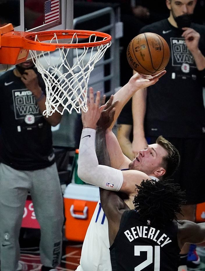 Dallas Mavericks guard Luka Doncic (77) scores past LA Clippers guard Patrick Beverley (21) during the second half of an NBA playoff basketball game at Staples Center on Tuesday, May 25, 2021, in Los Angeles. The Mavericks won the game 127-121.