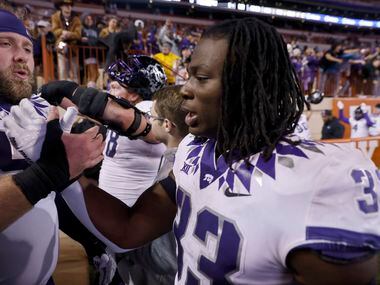 TCU Horned Frogs running back Kendre Miller (33) is congratulated by teammate linebacker...