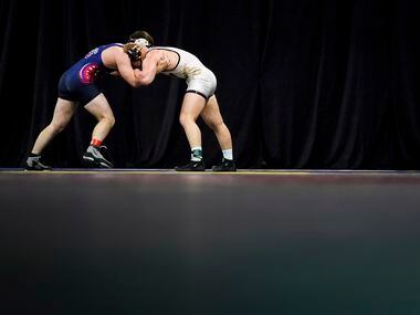 Jarrod Smiley of the University Of Central Florida (facing) wrestles Ethan Martin of Liberty...