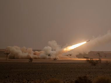 FILE - A launch truck fires the High Mobility Artillery Rocket System (HIMARS) at its...