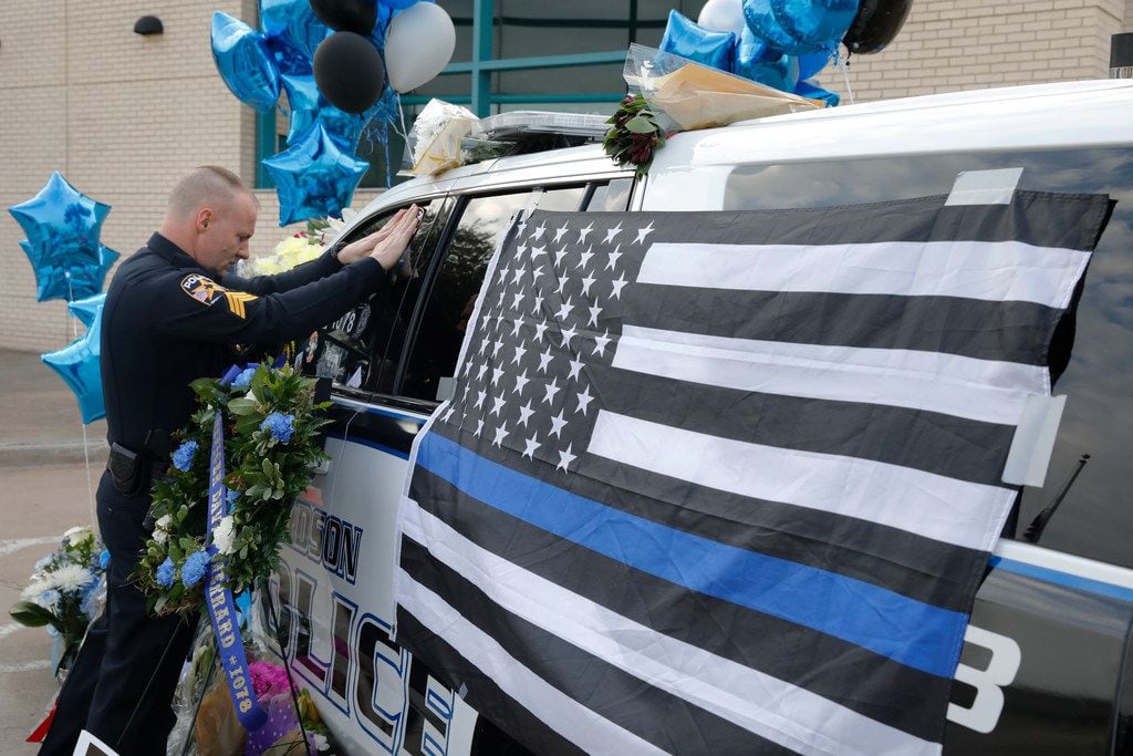 Rockwall police officer David Ray pays his respects to Richardson police officer David...