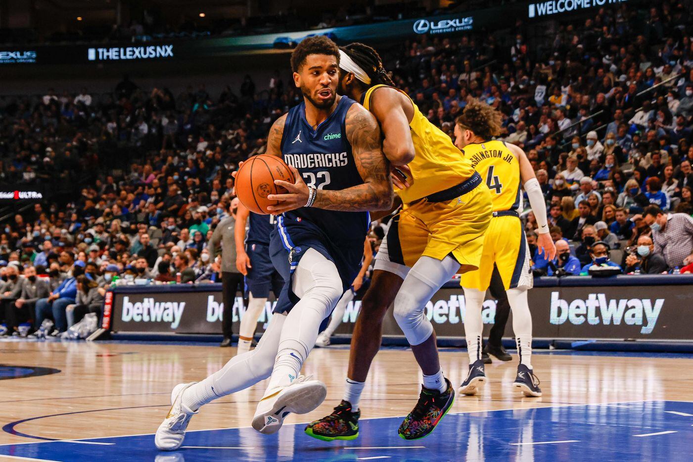 Dallas Mavericks forward Marquese Chriss (32) drives to the basket as Indiana Pacers forward Isaiah Jackson (23) tries to block him during the second half at the American Airlines Center in Dallas on Saturday, January 29, 2022.