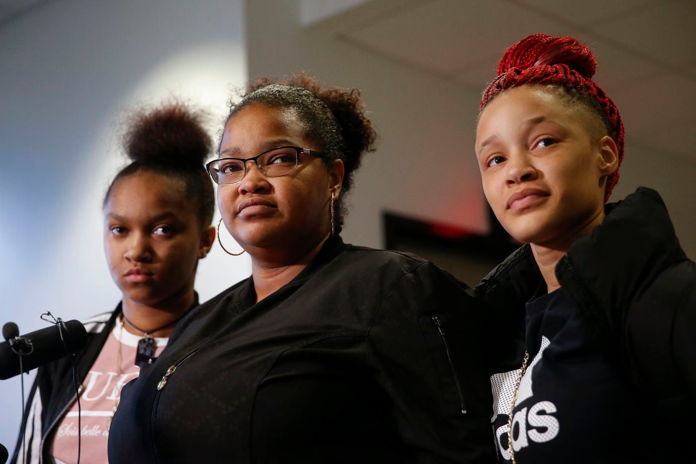 Shaquana Persley (center) and daughters Kayla Randle (left) and Shiniece Richards speak to media after Desmond Jones was sentenced to 99 years in prison for engaging in organized criminal activity. (Ryan Michalesko/The Dallas Morning News)