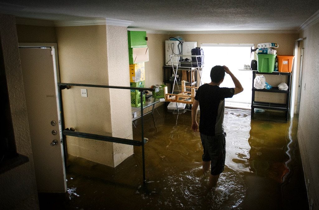 Jeff Liu pauses while retrieving his belongings from his west Houston apartment which was...