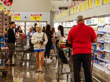 Customers do their regular grocery shopping at the new H-E-B store that opened its doors at...