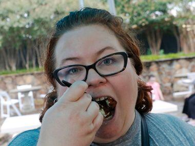 Shannon Sutlief, of The Dallas Morning News GuideLive team samples the Tamale Donut on...