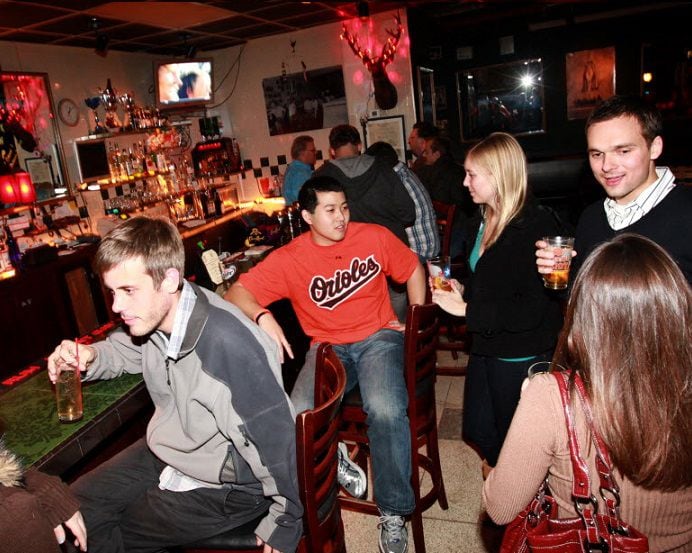 Guests enjoy the drinks and conversation at the Windmill Lounge in Dallas, TX, on Nov. 6,...