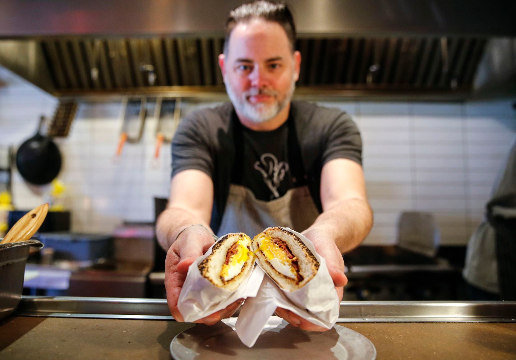 Resident Taqueria owner Andrew Savoie shows the bacon, egg and cheese on a kaiser roll.