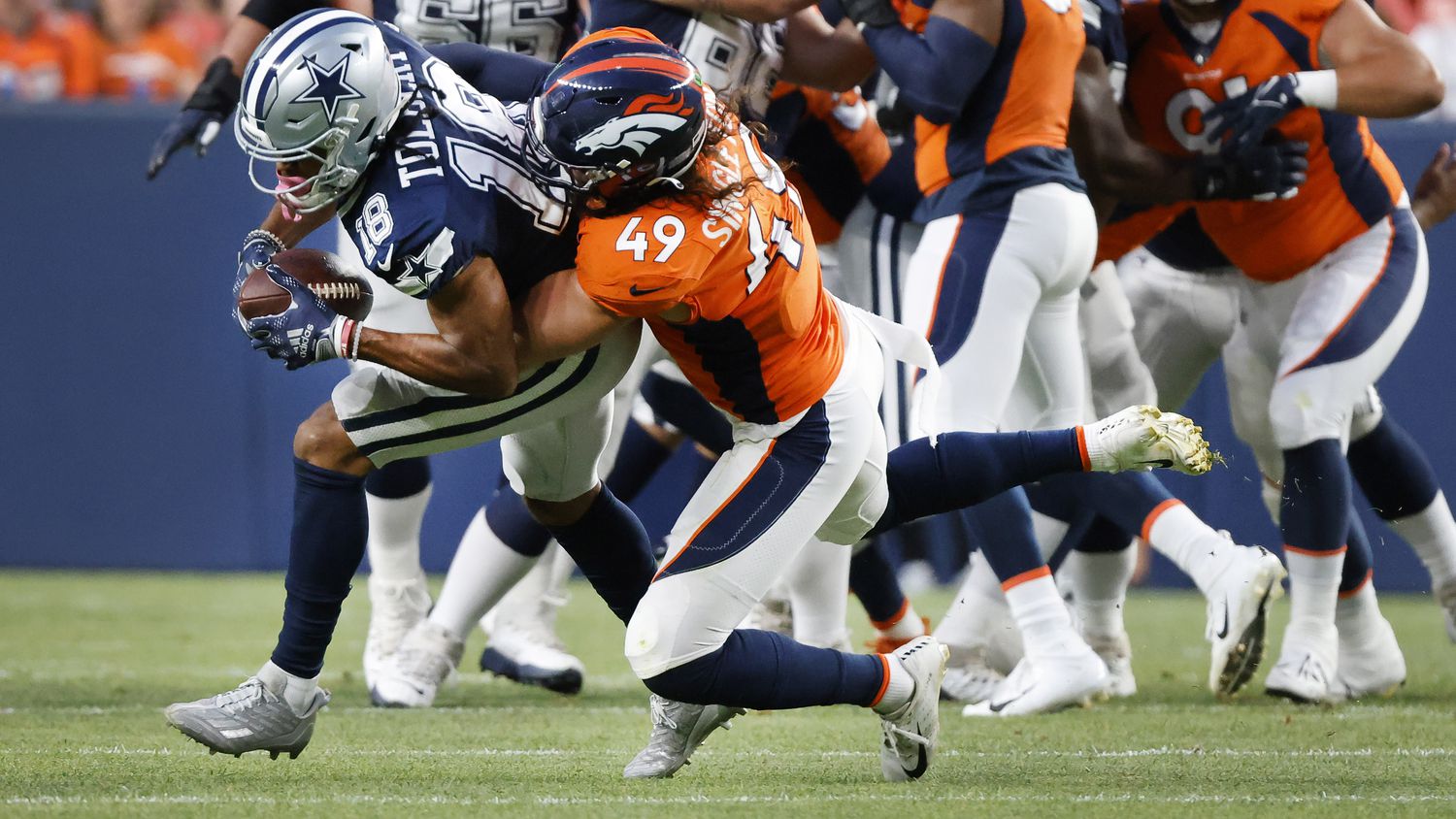 Denver Broncos linebacker Alex Singleton (49) brings down Dallas Cowboys wide receiver Jalen...