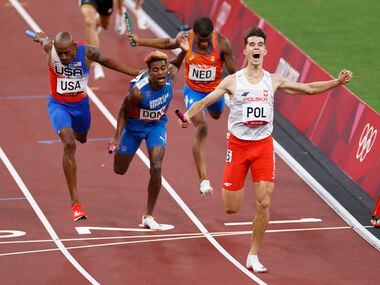 (From l to r) Poland's Kajetan Duszynski celebrates after winning and setting an Olympic...