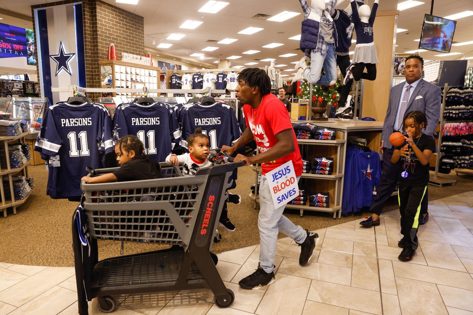 The Givens family walks through Scheels in The Colony during a Dallas Mavericks shopping...